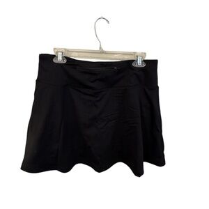 Black pleated tennis skirt/skort. Built in shorts and small zip up pocket XL